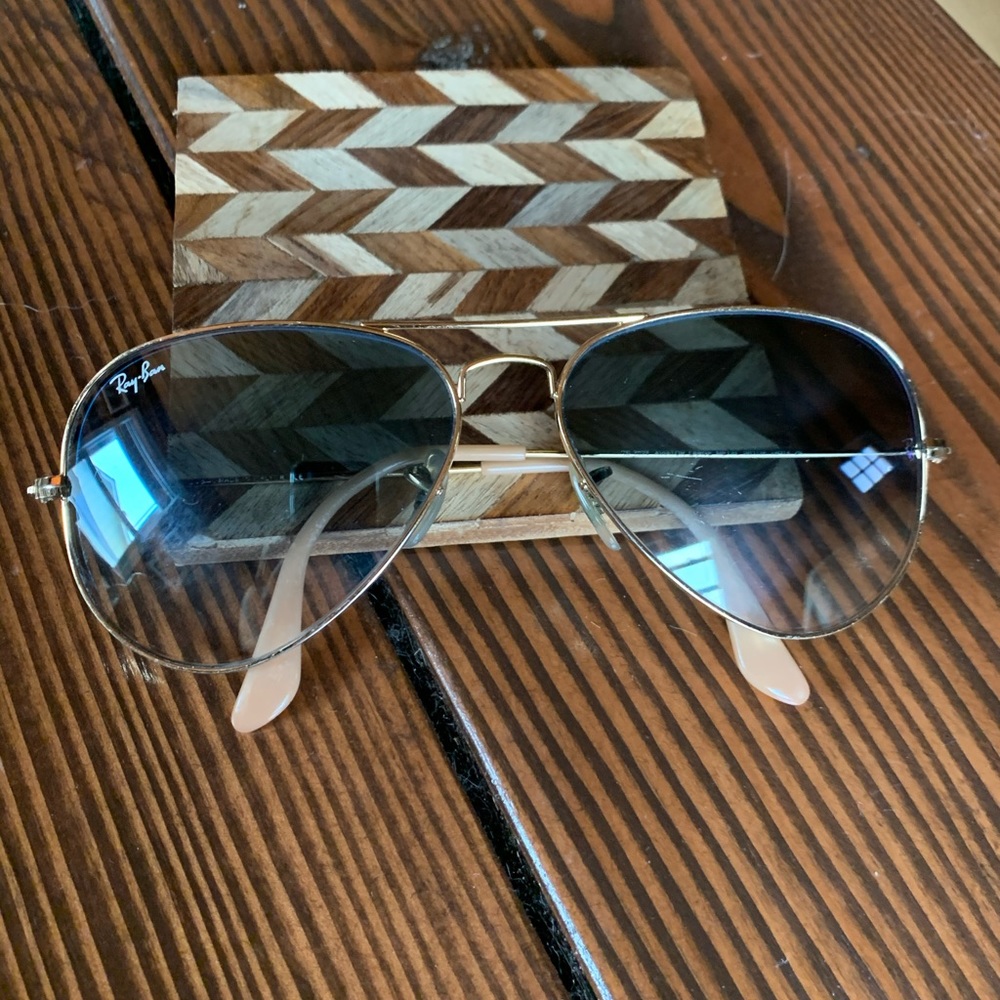 Gold Aviator Ray-Ban sunglasses with blue lenses
